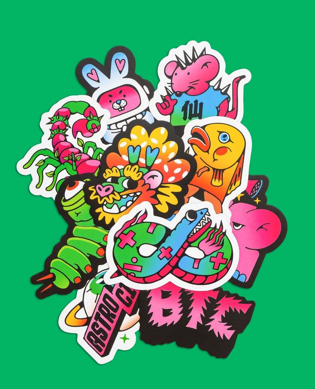 Astro Circo Studio die-cut sticker pack featuring bold cartoon characters on a green background
