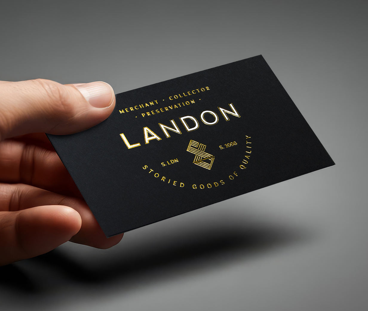 Hands holding beautifully crafted business cards with foil stamping.