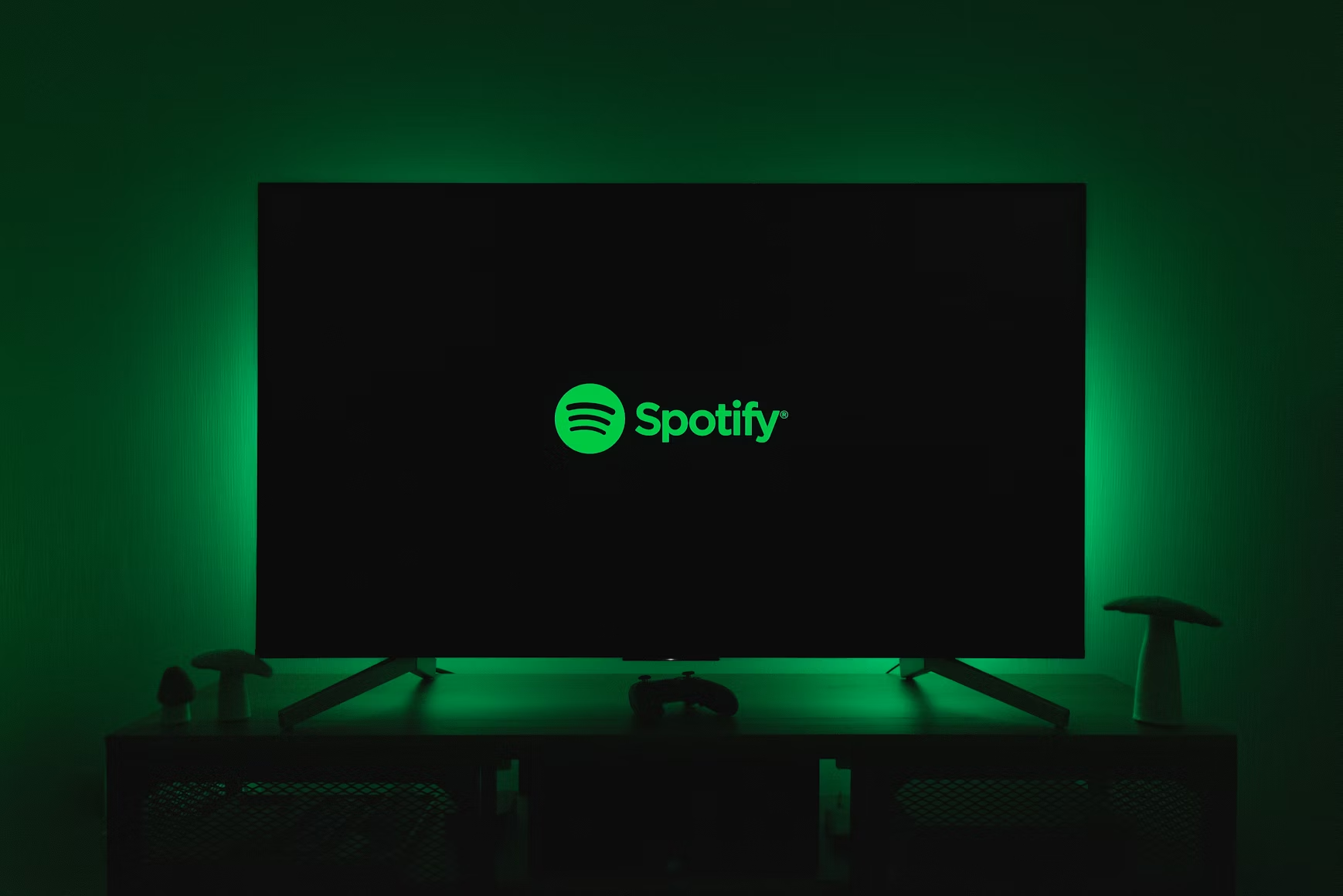 TV displaying the Spotify logo with the brand's green glow filling the surrounding room