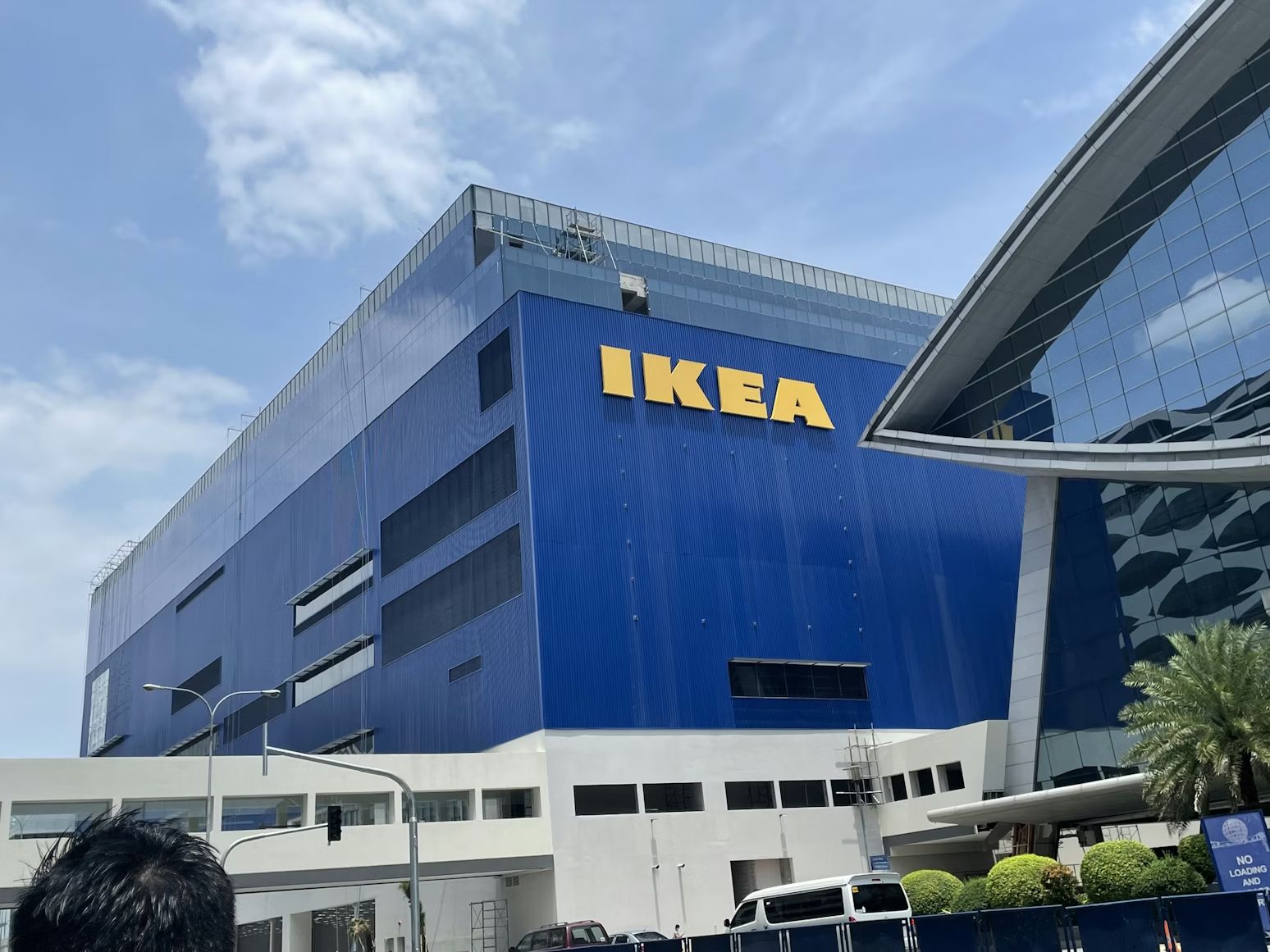 IKEA store exterior with the brand's signature blue building and yellow IKEA logo against a clear sky