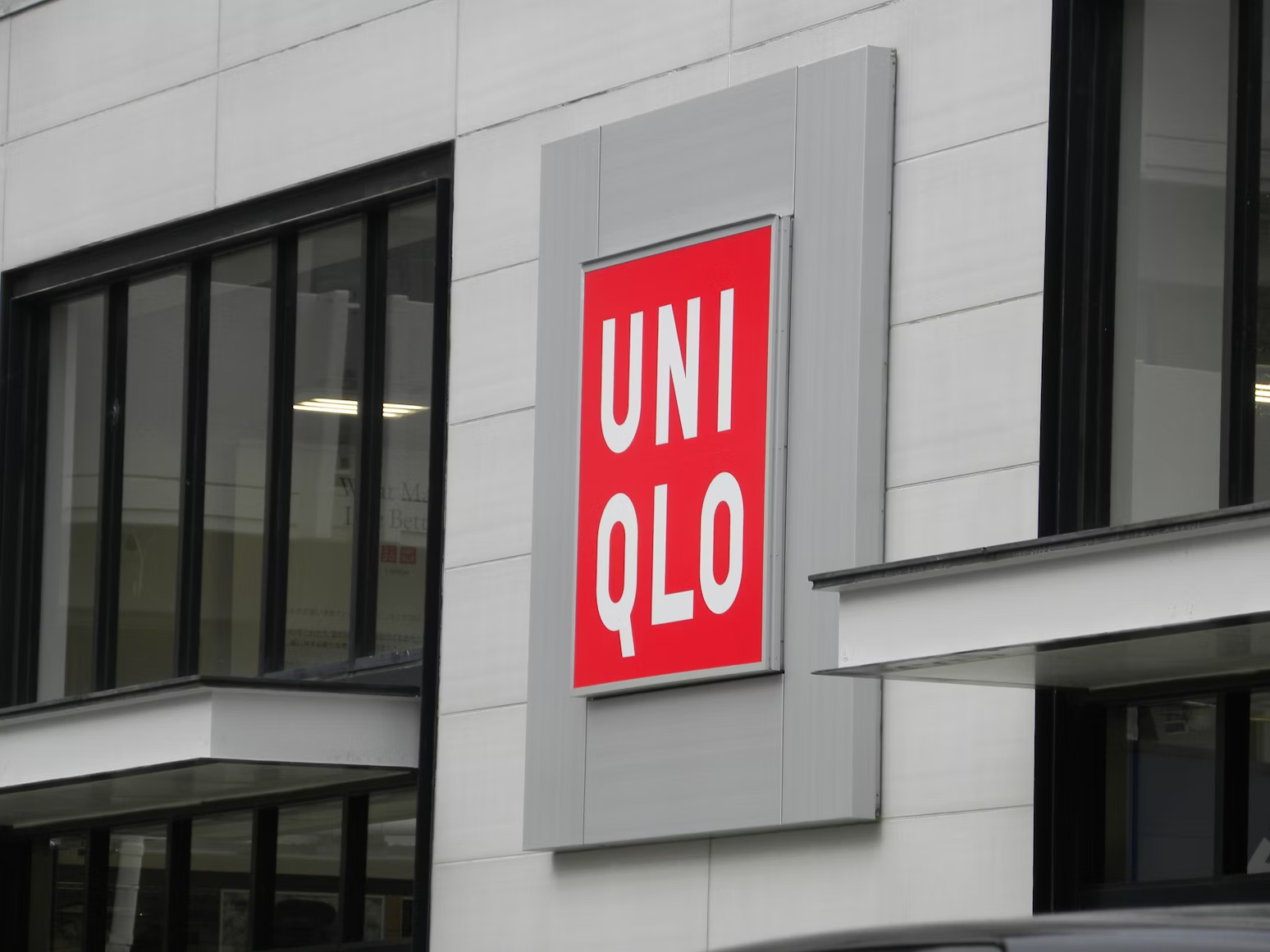 Uniqlo storefront with the brand's red square logo and white sans-serif lettering