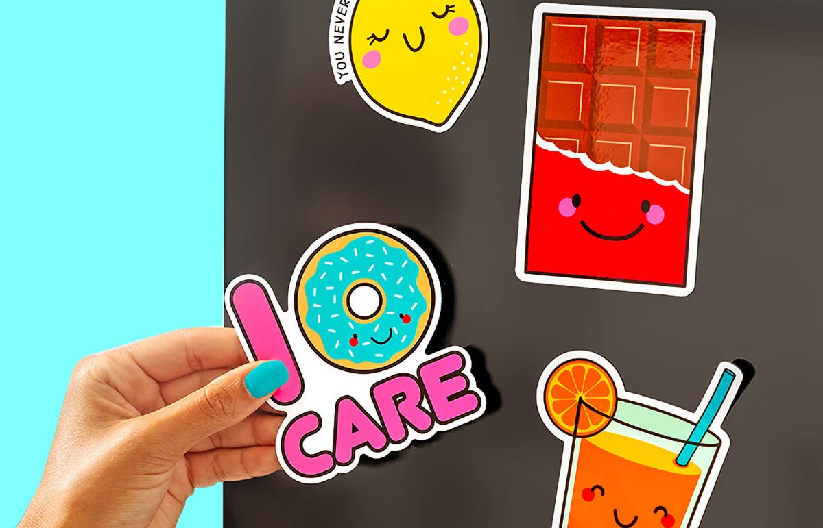 Custom printed fridge magnets arranged on a refrigerator door